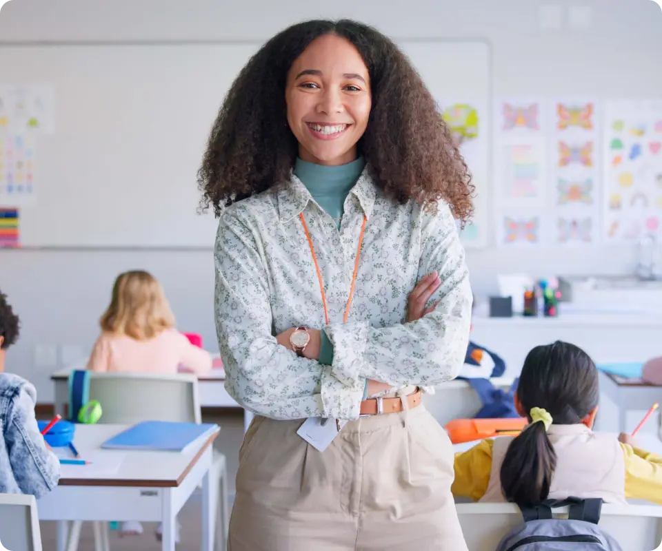 a woman teacher smiling in a classroom with children